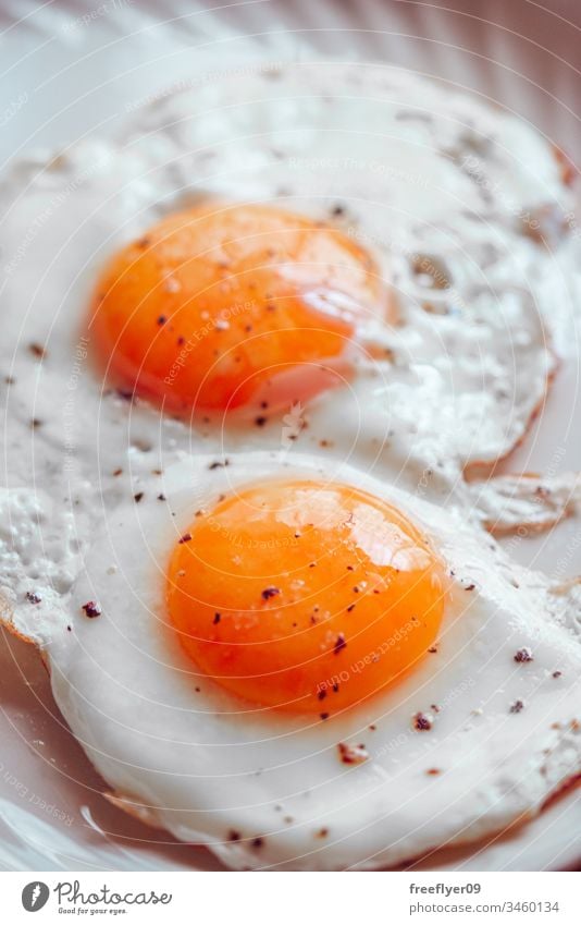 Fried eggs with salt and pepper fried eggs food cholesterol fast food gastronomy meal cooking background yolk white yellow protein breakfast cookery healthy