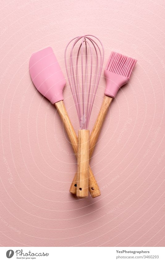 Baking tools on a pink table. Kitchenware flat lay above view baking baking utensils brush clean colorful cooking equipment home cooking household isolated