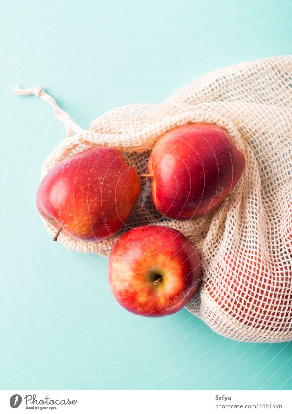 Fresh apples in reusable cotton bag produce grocery zero waste fruit background bright buy color concept cook food fresh green pastel red shop snack vitamin raw