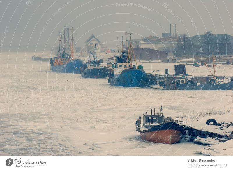 Fishing boats in the ice of a frozen bay baltic beach blue business cargo city coast cold commercial covered december europe european february fishing freight