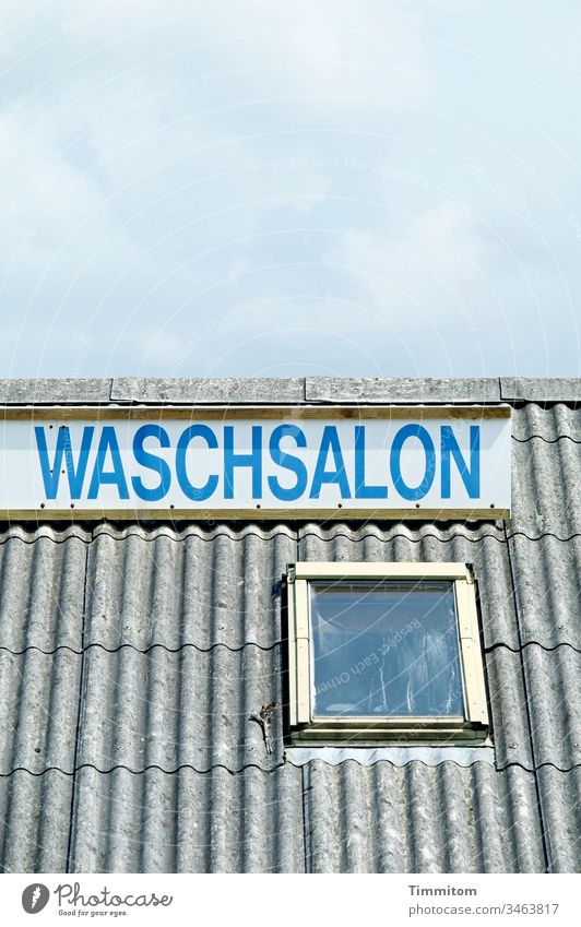laundrette Laundromat sign Advertising Roof Sky Blue Gray White Letters (alphabet) Exterior shot Deserted Skylight
