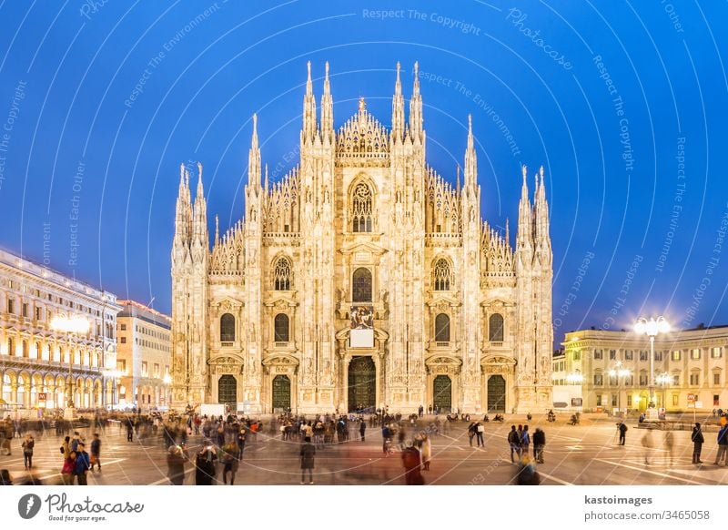 Milan Cathedral (Duomo di Milano) is the gothic cathedral church of Milan, Italy. Shot in the dusk from the square ful of people. milan italy religion duomo