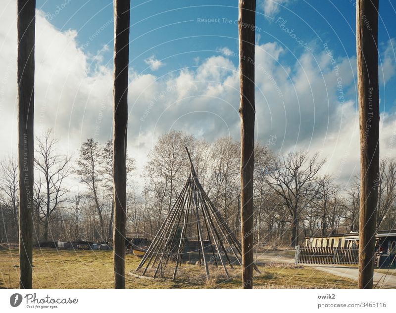 Through the bars Tee Pee tipi village Lausitz forest Scaffolding Framework trees Sky Clouds rods tent poles Joist Wood Long Thin Empty Exterior shot Deserted