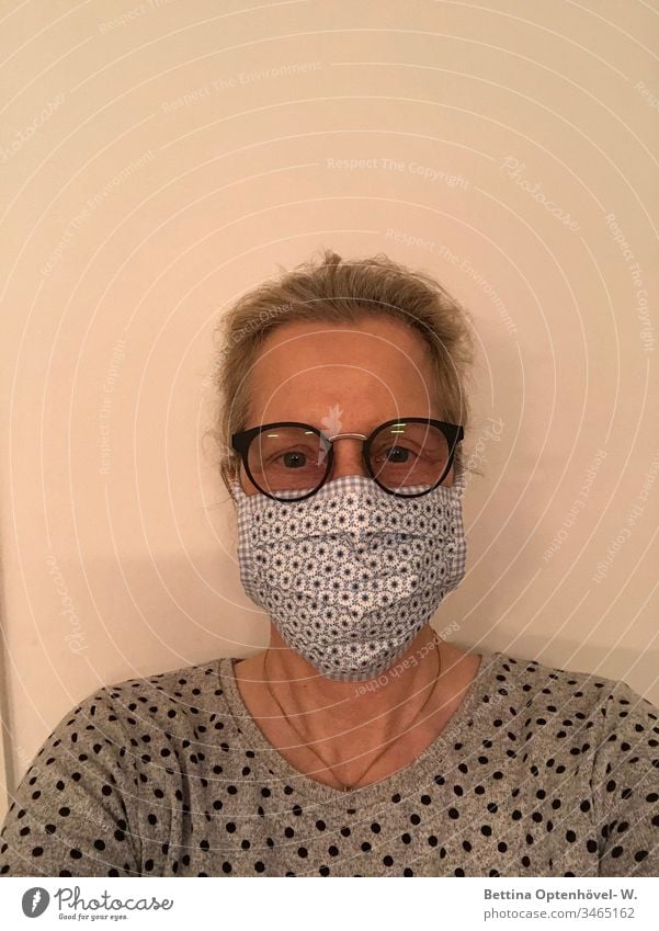 Woman with self-sewn protective mask corona pandemic Quarantine prevention Infection