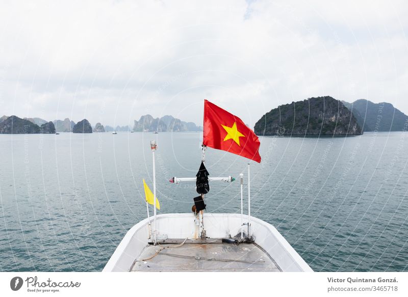 vietnam flag on a boat Halong Vietnam asia banner basin composure emblem freedom harbor lagoon lake landscape nature no person outdoors pond reservoir sea ship