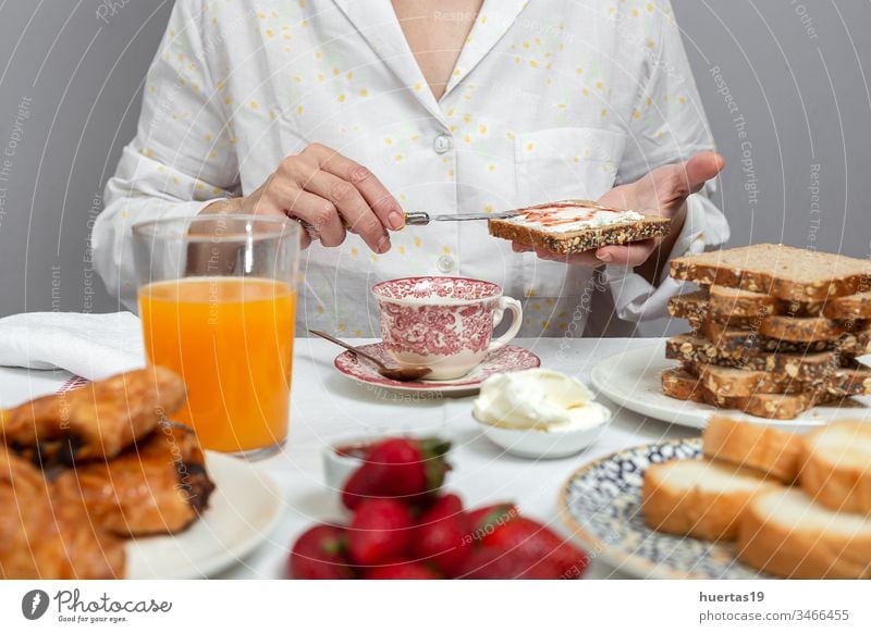 Unrecognizable woman having breakfast in pajamas at home in quarantine food morning lifestyle unrecognizable coronavirus covid-19 female eating white fresh