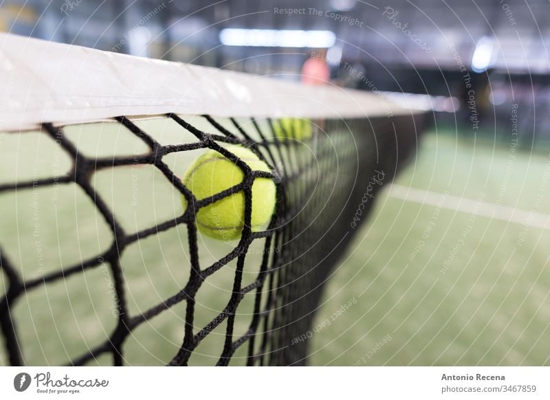 Ball shot versus the net paddle-tennis padel paddle tennis ball sport sports recreation equipment nobody focus in foreground leisure bokeh indoors fail failure
