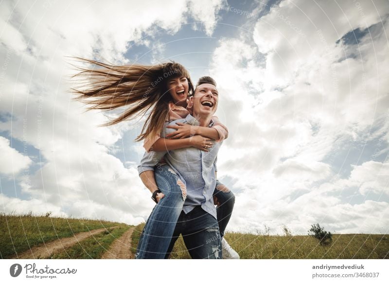 crazy young couple emotionally having fun, kissing and hugging outdoors. Love and tenderness, romance, family, emotions, fun. having fun together beach happy