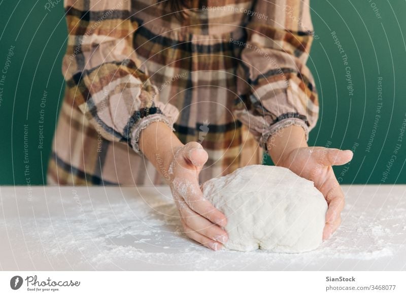 Woman prepares to her home handmade dough for bread, homemade cooking. woman hands white person powder pie pasta working bake-house food pizza female pastry raw