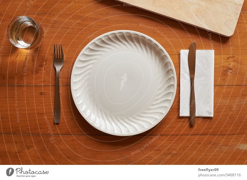 Porcelain plate and cutlery against a wood background mockup mock up flatlay flat lay kitchen cuttlery porcelain white wooden table from above cenital empty