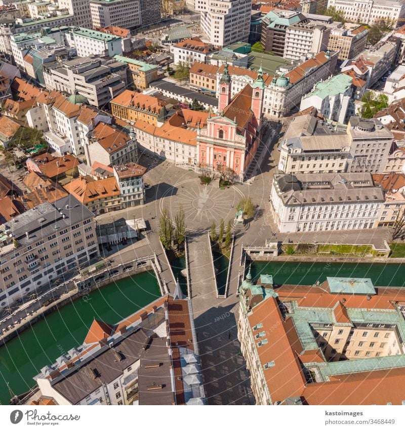 Aerial drone view of Preseren Squere and Triple Bridge over Ljubljanica river,Tromostovje, Ljubljana, Slovenia. Empty streets during corona virus pandemic social distancing measures.