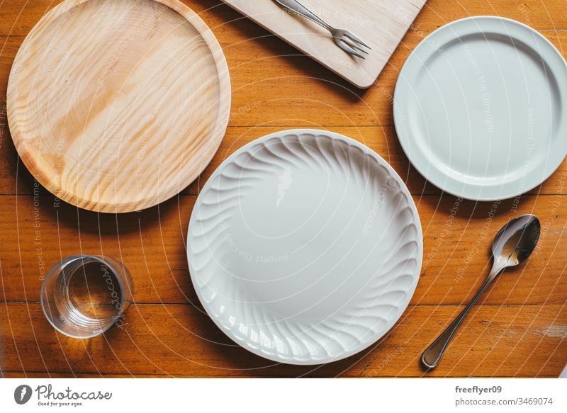 Flat lay of three plates and some cutlery mockup mock up flatlay flat lay kitchen cuttlery wood porcelain white wooden table from above cenital empty cook lunch