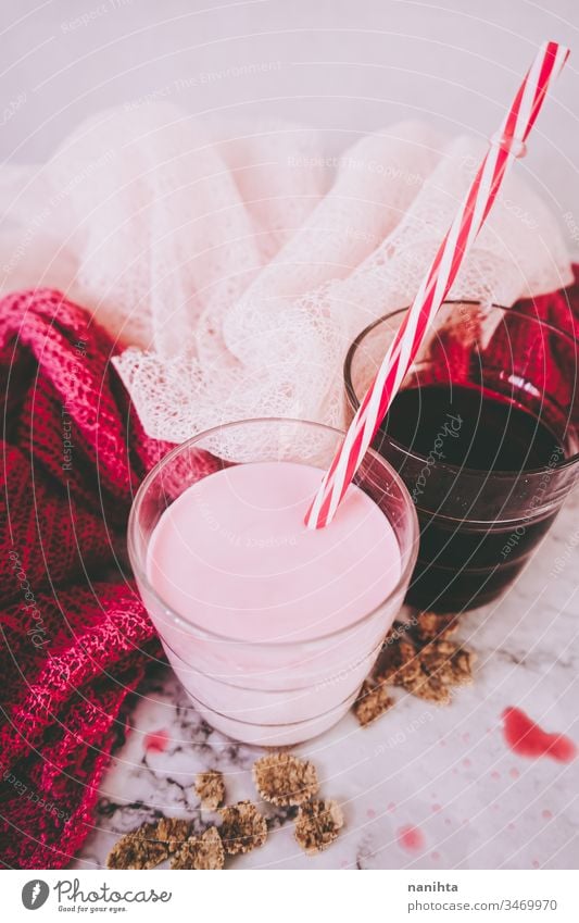 Beautiful composition in pink and white of milkshake and red tea strawberry diary delicious juice berries raspberry juice infusion temptation healthy glass