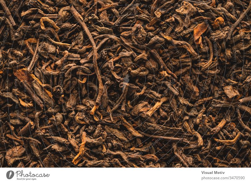 Close-up of dried black tea leaves with cinnamon close-up color detail texture drink infusion brew indoor interior dry abstract background textural indoors