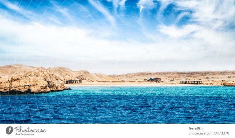 rocky coast of the Red Sea and
blue sky with clouds Egypt Sharm el Sheikh climate day desert deserted destination empty exotic horizon island koga lagoon