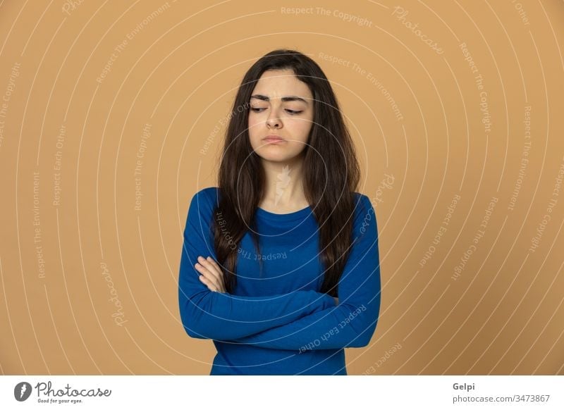 Brunette young girl wearing blue jersey person yellow sad unhappy worry depressed angry serious portrait expression gesture beautiful female woman fashion