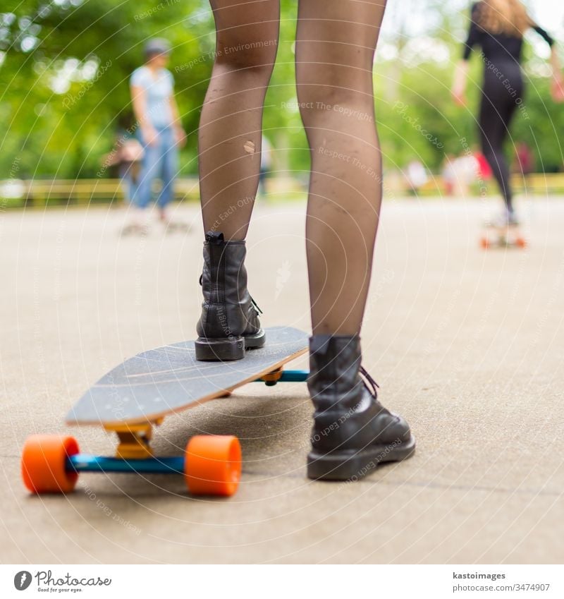 Girl practicing urban long board riding. skateboard sport one lifestyle skateboarding fun skater girl youth young summer street fashion woman cool casual trendy