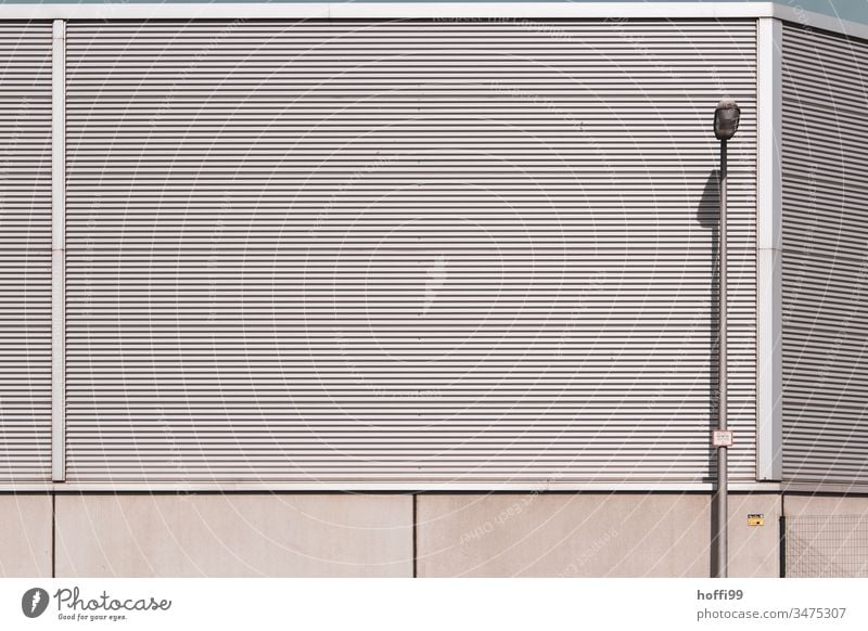 monotone metal facade with street lamp Warehouse Storage Hall Industrial Photography Corrugated iron wall Corrugated sheet iron corrugated sheet metal facade