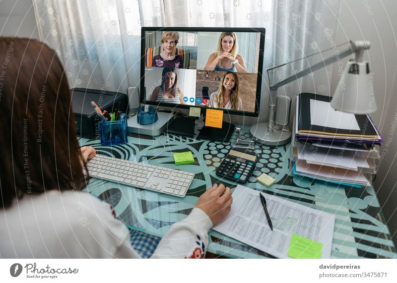 Woman talking on video call with friends unrecognizable woman social distancing covid-19 quarantine coronavirus computer internet video conference family