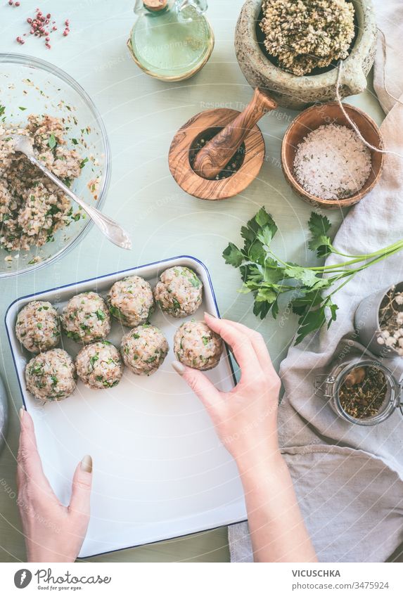 Female hand make buckwheat balls on kitchen table background with herbs and spices, top view. Healthy homemade food female healthy appetizer cook cooking