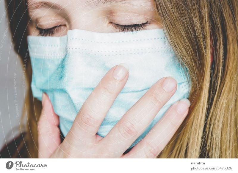 Young woman wearing a protective face mask covid 19 flu influenza coronavirus pandemic epidemic illness respiratory illness social distance contagion risk