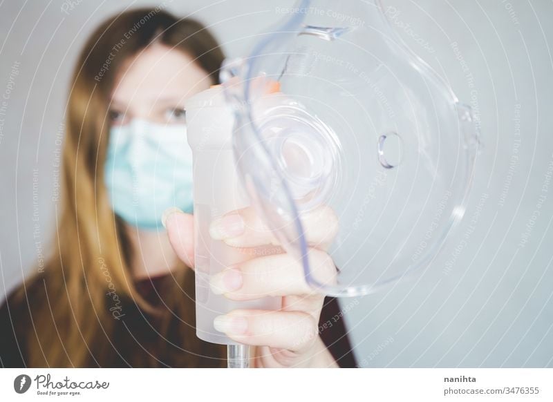 Young woman wearing a protective face mask covid 19 flu influenza coronavirus pandemic epidemic illness respiratory illness social distance contagion risk