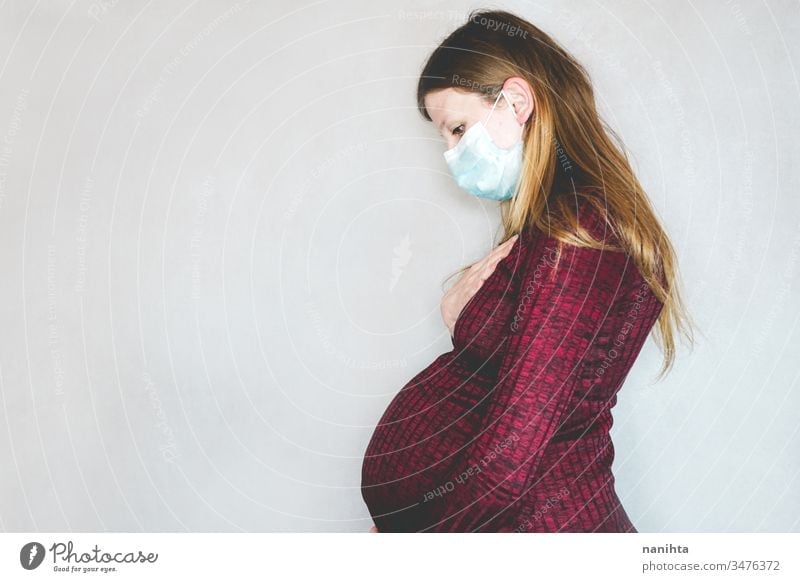 Young pregnant woman wearing a face mask covid 19 flu influenza coronavirus pandemic epidemic illness pregnancy risk group respiratory illness social distance