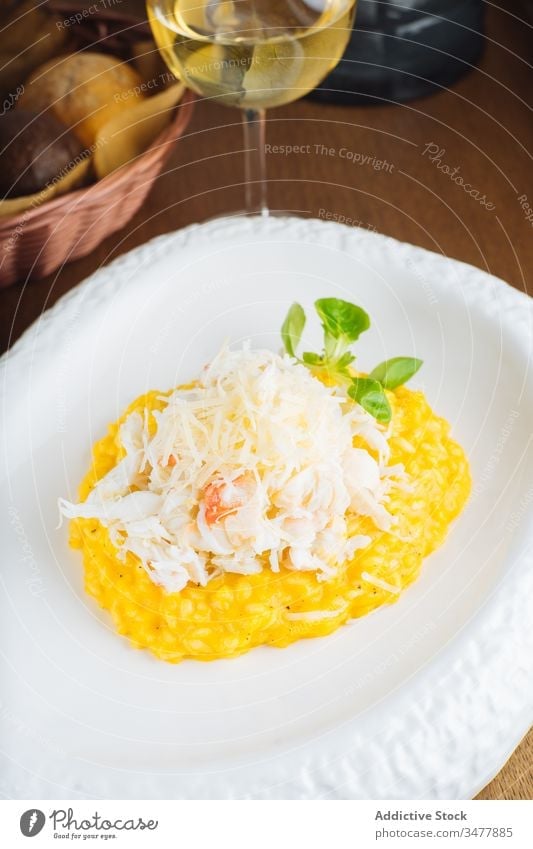 Delicious traditional risotto with cheese rice plate serve saffron yellow dish gourmet delicious food tasty meal healthy cuisine nutrition dinner wine