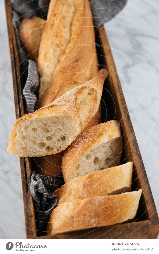 Fresh cut bread on wooden tray baguette fresh slice table bakery loaf crust homemade artisan marble food tasty delicious meal rustic pastry baked bun healthy