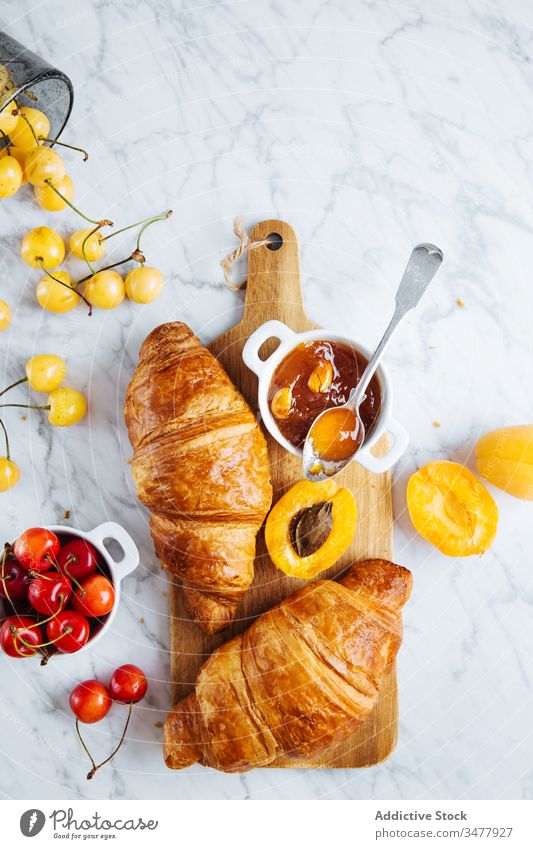 Croissant and apricot jam on wooden board croissant pastry breakfast bake fresh natural morning food serve delicious tasty meal tradition gourmet nutrition