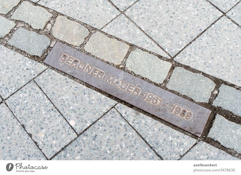 commemorative plaque marking former border Berlin Wall berlin wall germany berliner mauer pavement street sidewalk europe travel destination landmark tourism