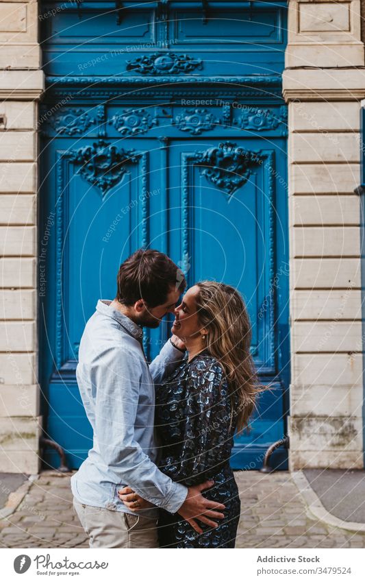Lovely couple kissing near old building love together relationship embrace happy city historic stone travel romantic boyfriend girlfriend hug date affection