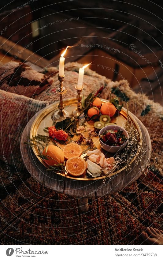 Table with burning candles and fruits on tray table composition moroccan design serve tradition treat fresh arrangement decoration natural delicious assorted