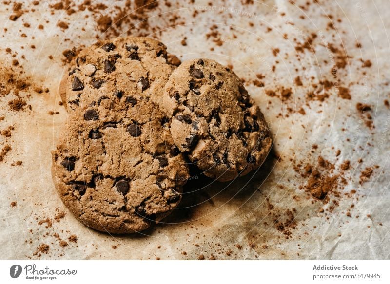 Tasty chocolate cookies on wooden table baked pastry biscuit sweet paper food dessert dark tasty homemade snack fresh delicious yummy meal cuisine treat chip