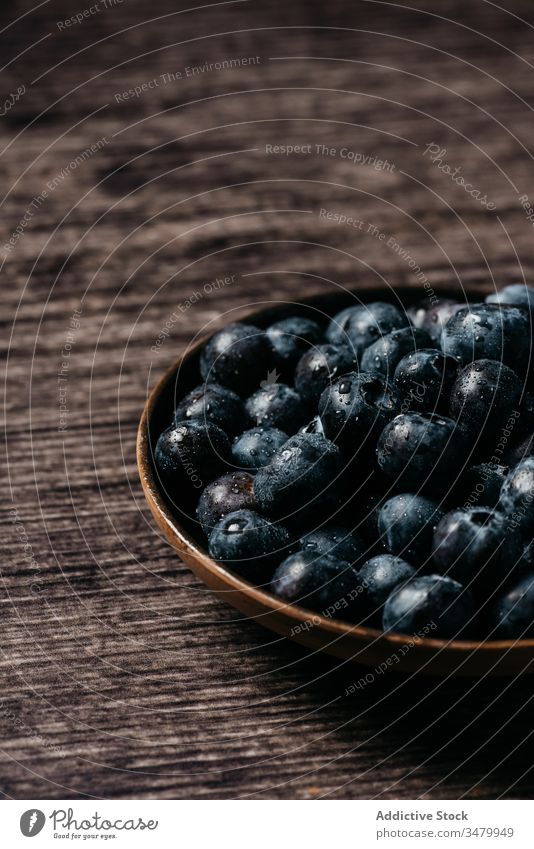 Fresh blueberries on wooden bowl on table blueberry dark food fresh natural ripe delicious tasty ingredient healthy nutrition vegetarian vitamin raw meal