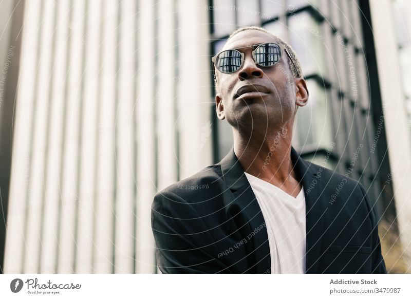 Stylish black businessman on street style city building success ethnic urban modern confident male professional entrepreneur contemporary executive smart