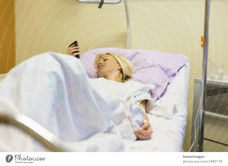 Bedridden female patient recovering after surgery in hospital care. bed sick woman healthcare medical medicine ill recovery illness ward bedridden treatment