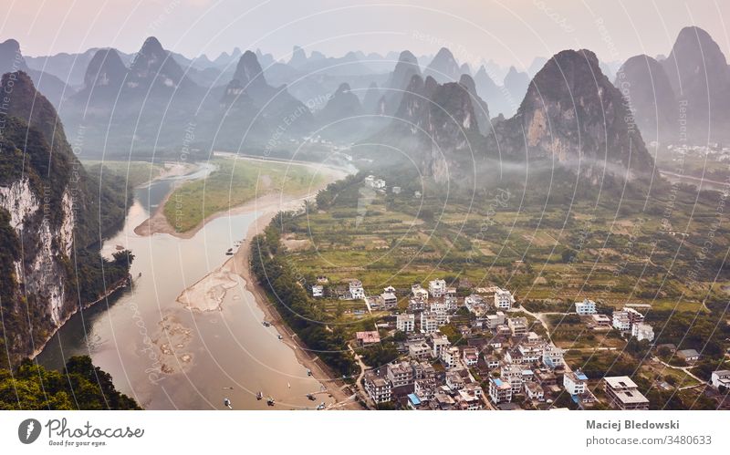 Karst landscape with Li River at sunset, China. karst Asia travel Xingping aerial beautiful dusk mountains nature picture river rural scenery scenic sky tourism
