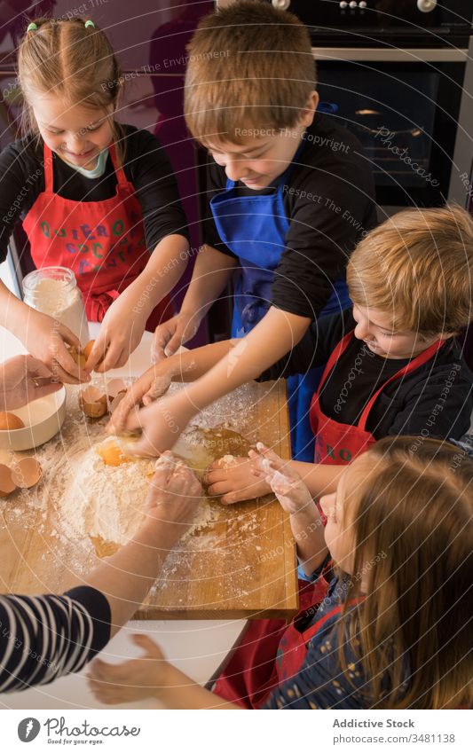 Children preparing dough together kid kitchen cook flour table prepare food children apron cute ingredient pasta help little cuisine meal home lifestyle counter