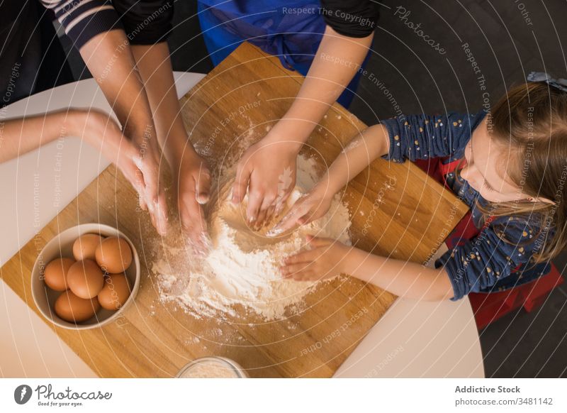 Children preparing dough together kid kitchen cook flour table prepare food children apron cute ingredient pasta help little cuisine meal home lifestyle counter