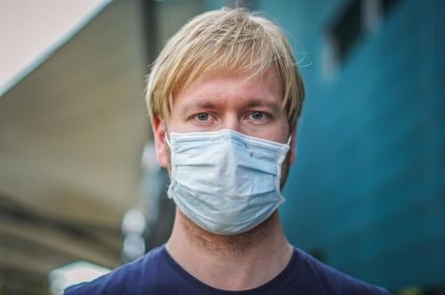 Coronavirus: danger of Covid-19. Portrait of a young man wearing a face mask, biological danger person Epidemic Protection Virus flu Environmental pollution