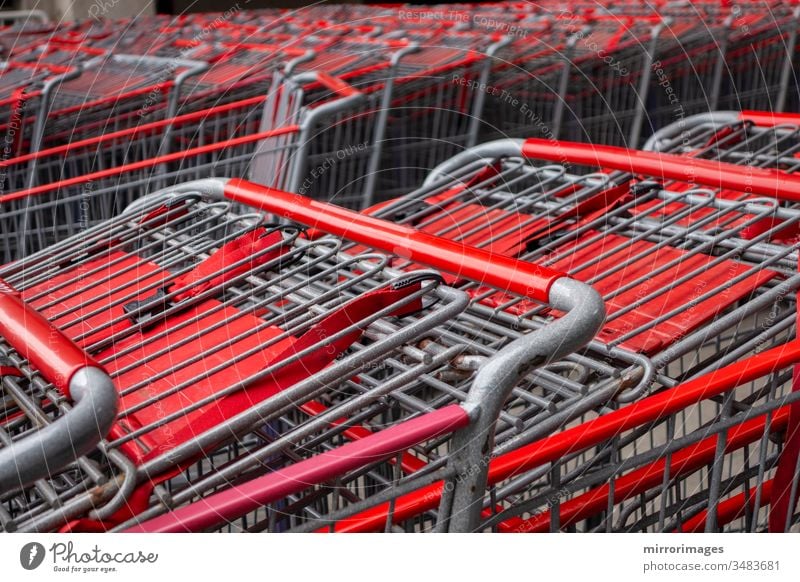 metal and red Shopping Cart Trolley in row Retail department store Consumer Business concept nested parked push close-up stack industry shopping cart nobody