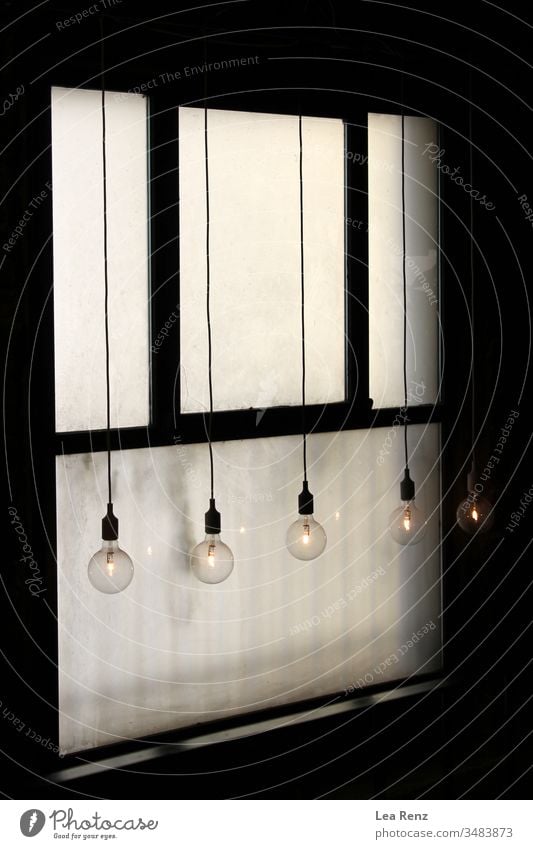 Lightbulbs hanging in front of an old window. lightbulbs design white metal door wall power electric home equipment isolated box security control button panel