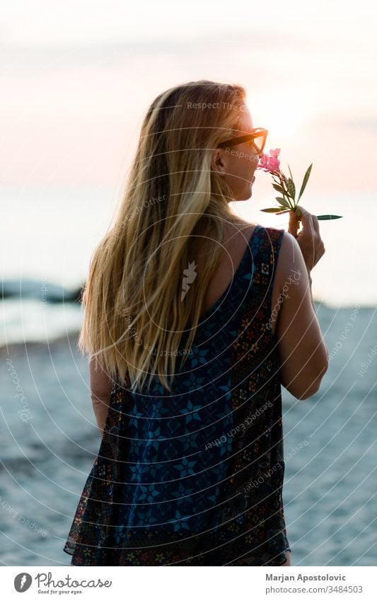 Young woman enjoying sunset at the beach adult beautiful beauty carefree dusk enjoyment evening exotic female flower freedom fun girl happiness happy hawaii
