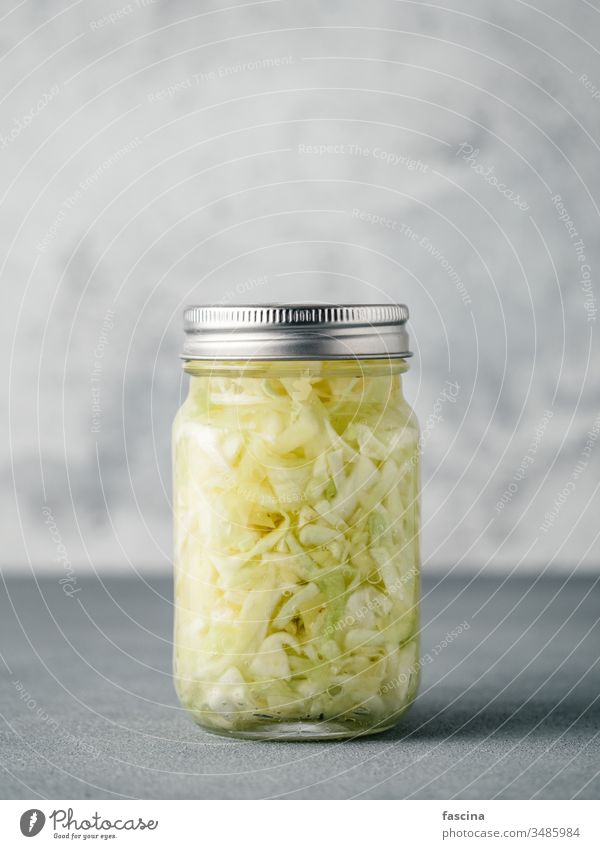 Sauerkraut in open glass jar, copy space sauerkraut cabbage fermented food dish raw barrel sour cumin salad stewed background white homemade pickled coleslaw