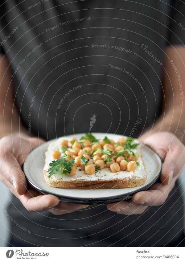 Vegan sandwich with chickpea in male hands vegan toast plate ready-to-eat copy space ideas healthy breakfast lunch snack concept text food meal cooking