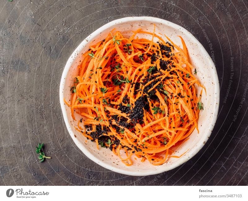 Raw carrot noodles or spaghetti, top view spicy salad diet food fresh healthy lunch plate preparation raw vegan vegetarian appetizer dish vegetable veggie