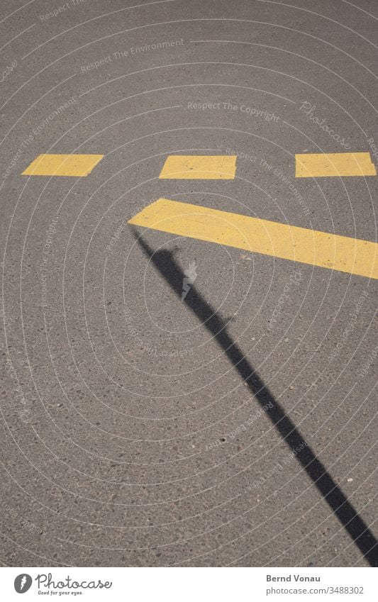 road marking Street Marker line Yellow Black Shadow Gray Asphalt Sunlight Signs and labeling Traffic infrastructure Under three Rectangle Line graphically