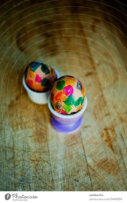 two Easter eggs Egg Egg cup Breakfast Hen's egg variegated Colour Wood board Wooden board breakfast board Eggshell Cholesterol Point colored circles