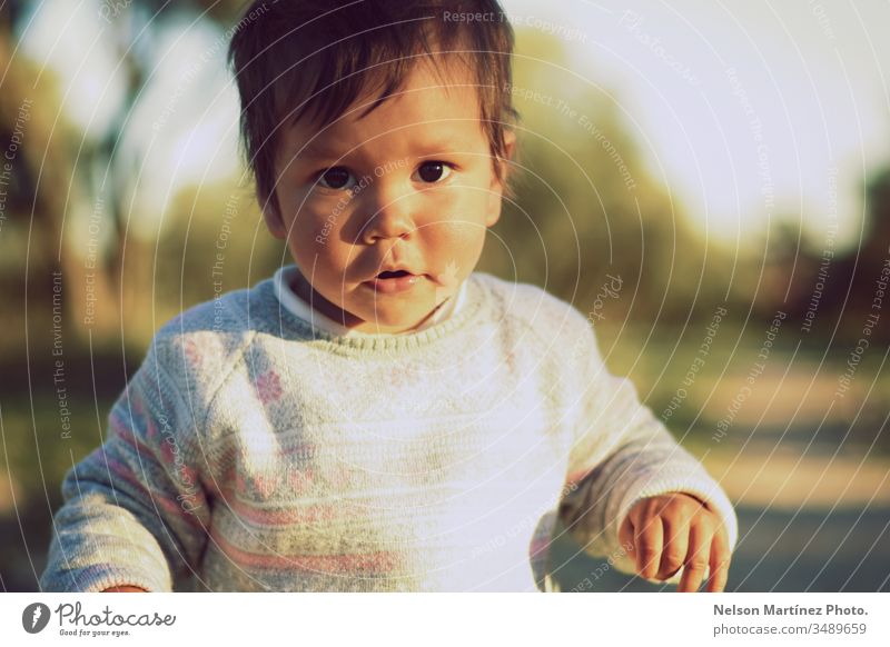 Portrait of a cute child girl walking in the park. baby bokeh portrait Portrait photograph Face Innocent Infancy sweet hispanic latina Life family